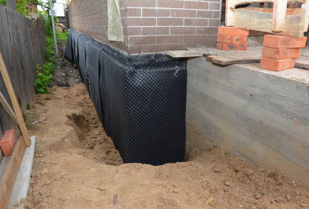 Happy homeowners after waterproofing job in Warren